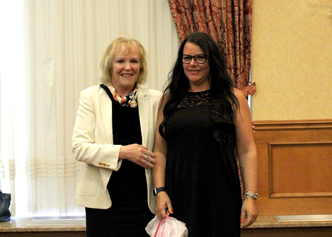 Photo: Michelle Purcell (right) receiving her award from President and CEO, Jo-Anne Poirier