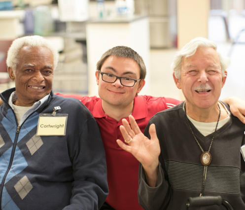 Three people in a group photo excited to buy raffle tickets