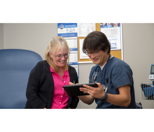 Two people looking at a tablet together