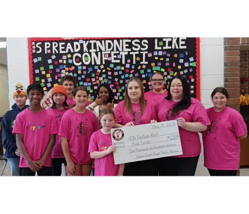 Indian Creek Road Public School student t-shirt designers and staff present a cheque for $1,600 to Kids’ Circle staff.