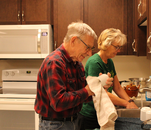 Bev at a sink doing dishes with a VON PSW. 