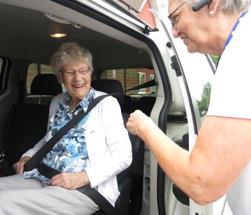 Client with VON staff as they are buckles in for a transportation service.