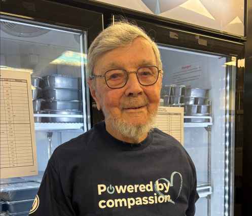 Photo of Carlton infront of a freezer for Meals