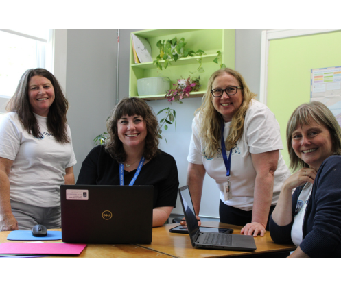Photo of four staff members with technology