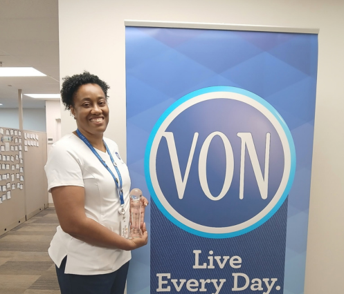 VON IEN Karen Hall posing with her award