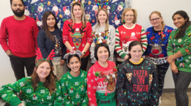Group of VON staff wearing festive holiday sweaters