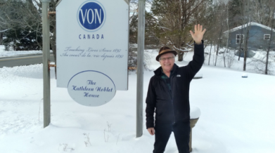 VON Volunteer in front of VON sign