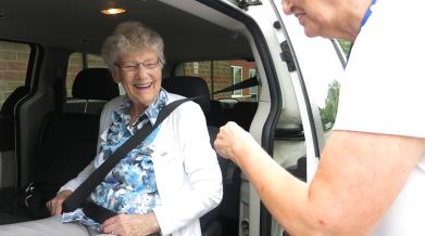 Client with VON staff as they are buckles in for a transportation service. 