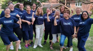 A group of VON staff posed outdoors wearing their VON Powered by Compassion t-shirts.