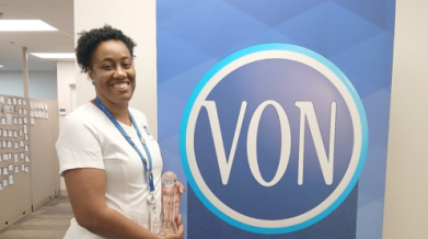 VON IEN Karen Hall posing with her award