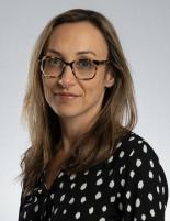 Headshot of Sara Gottlieb, General Counsel and Chief Privacy Officer. Wearing glasses and a black blouse with white polka dots  