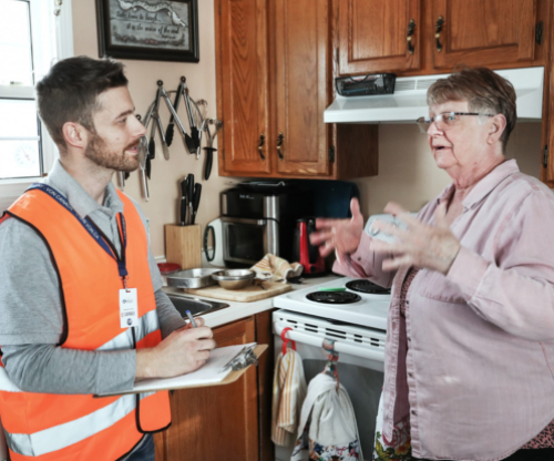 CAPABLE photo of a handy worker and client together in kitchen